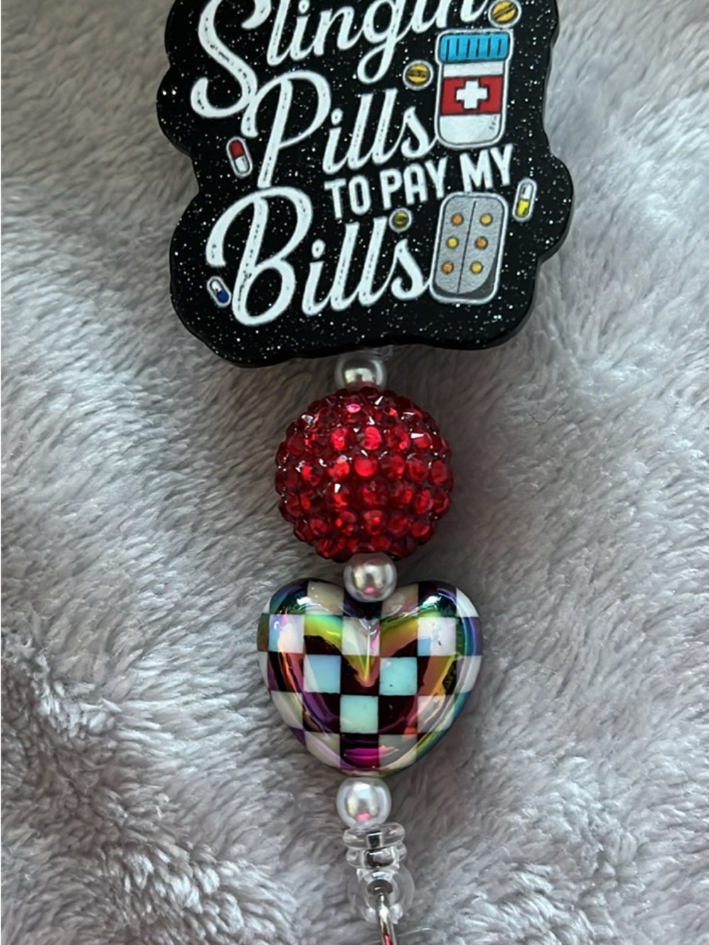 Slingin' Pills To Pay My Bills Badge Reel with Red Crystal and Checker Heart